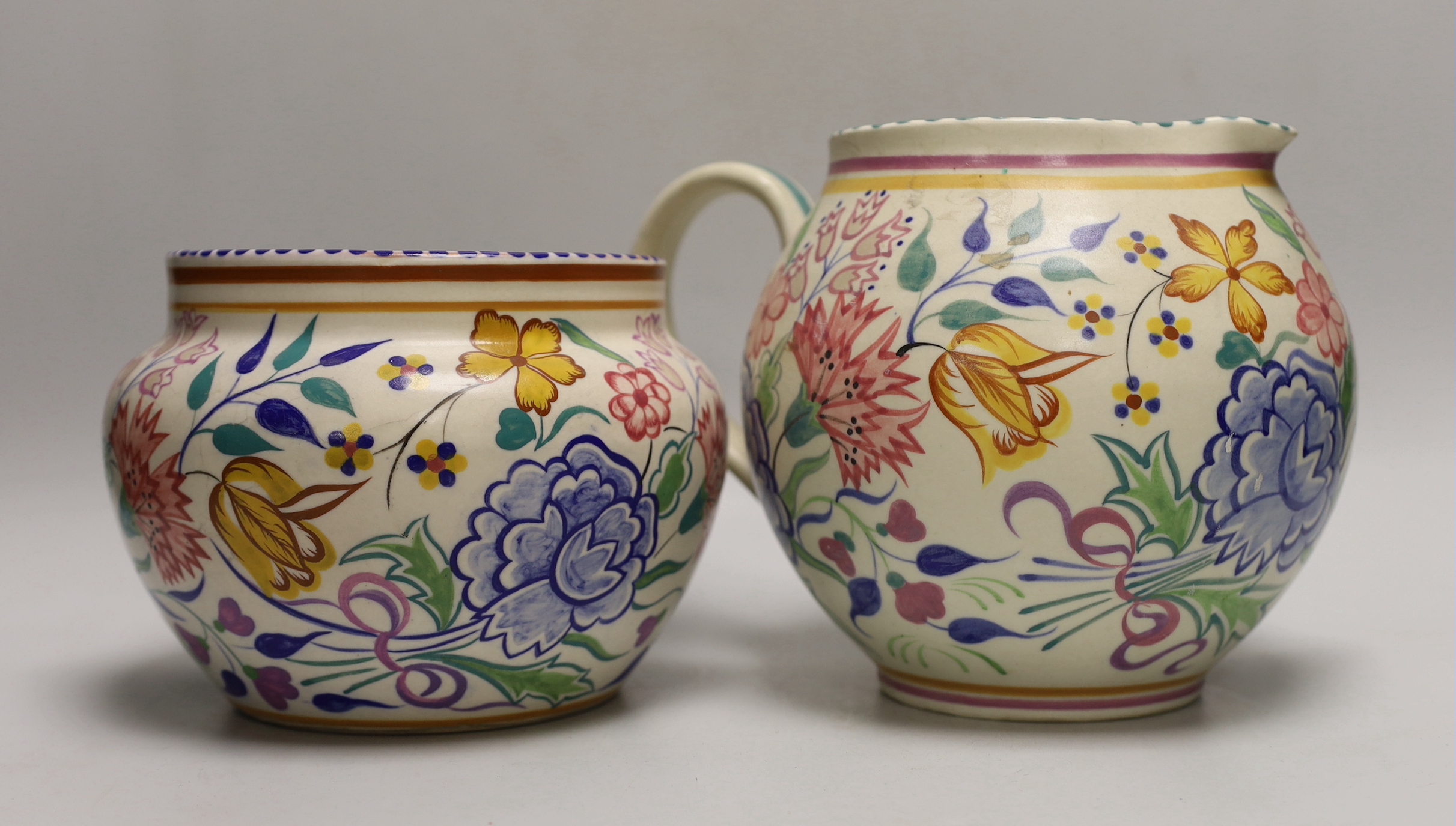 A Poole pottery tulip floral vase and jug and an hors d'oeuvre dish
